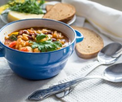 soup in a bowl on a table with a side of bread