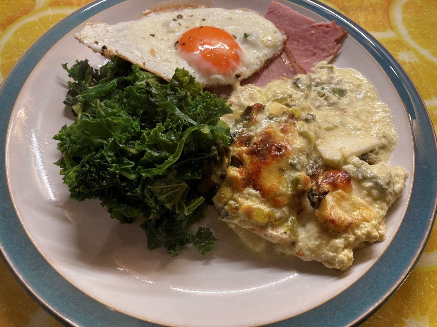 celeriac gratin with ham, fried egg and kale
