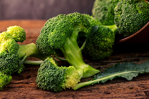 The selective focus  fresh green broccoli on wooden plate
